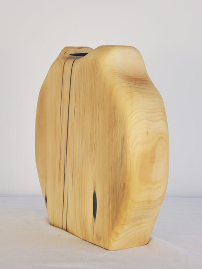 Wooden vase with a natural finish on a white background