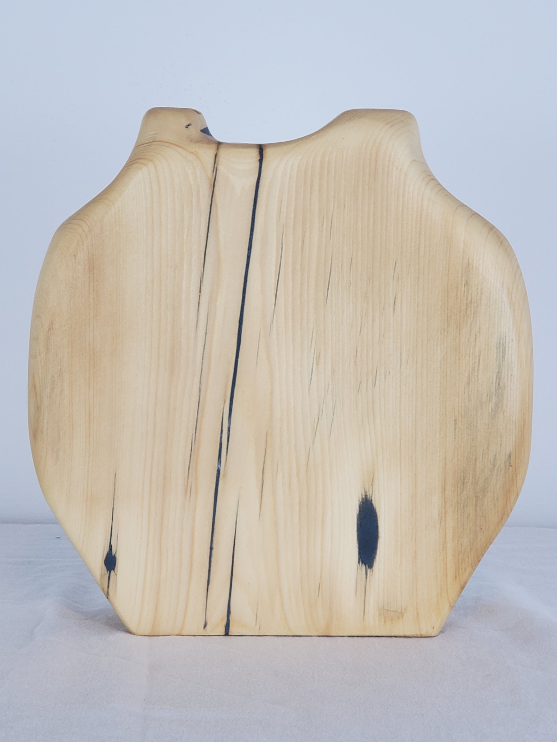 Wooden bud vase with a natural finish on a light gray background