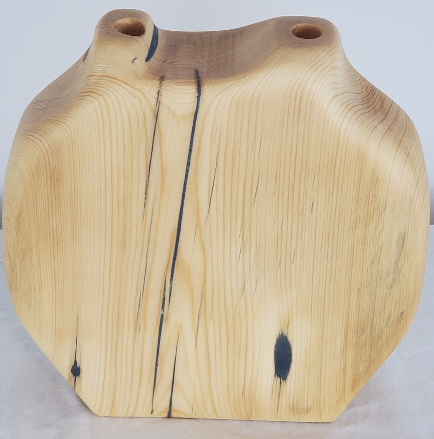 Wooden vase with natural grain and texture on a light background