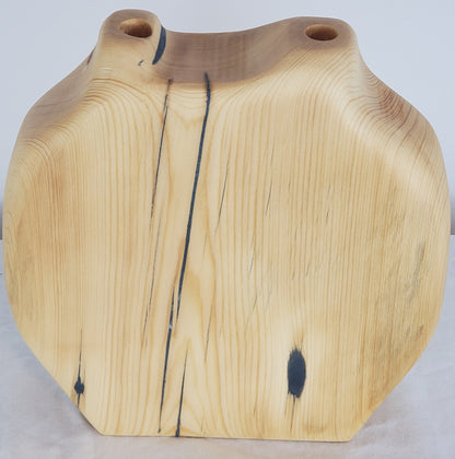 Wooden vase with natural grain and texture on a light background