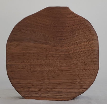 Wooden bud vase on a plain background