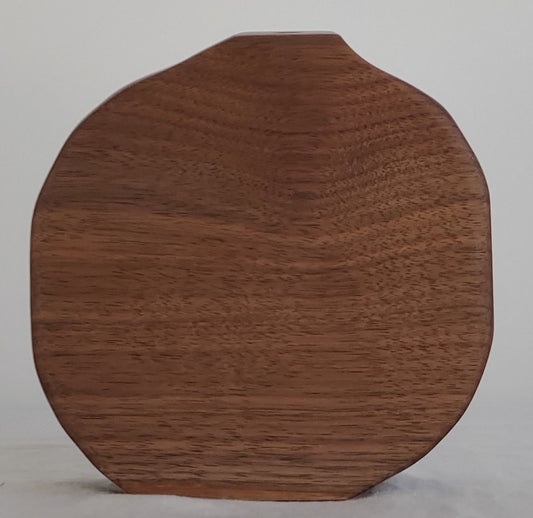 Wooden bud vase on a plain background