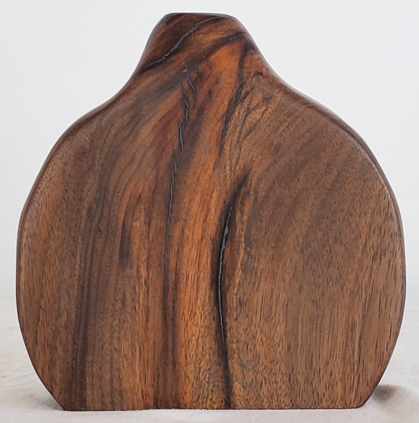 Wooden sculpture with a natural grain pattern on a white background