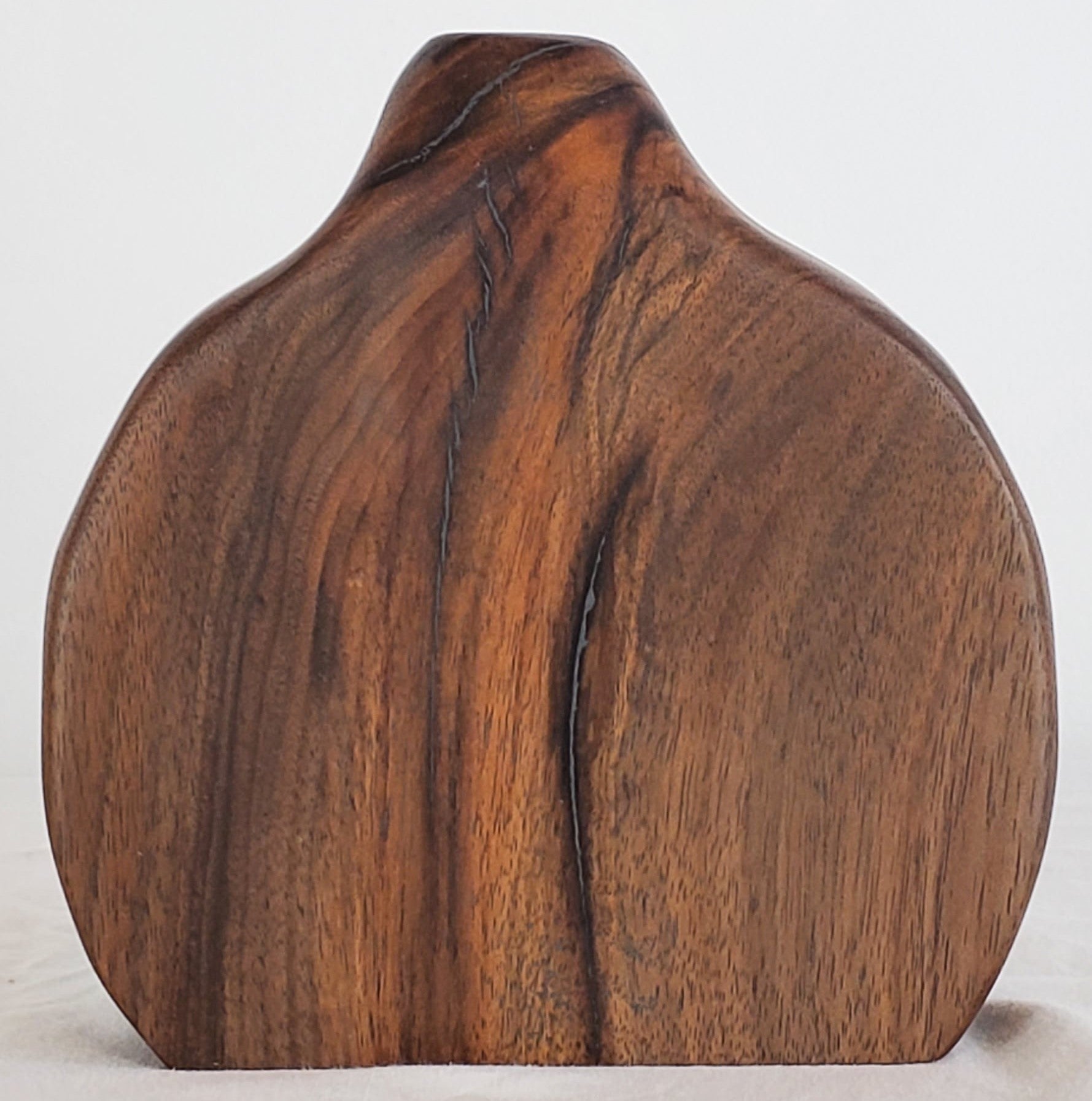 Wooden sculpture with a natural grain pattern on a white background