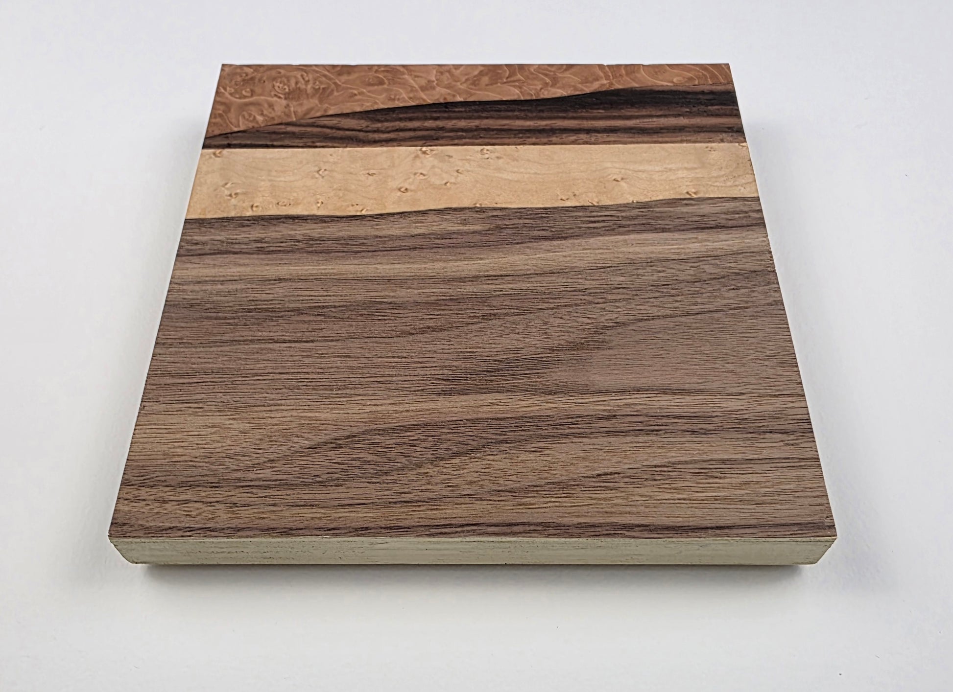 Wooden art with a wavy pattern on a plywood backing. Jennifer Mourato Art Collection