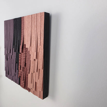 Wooden wall art piece with a geometric pattern on a white background