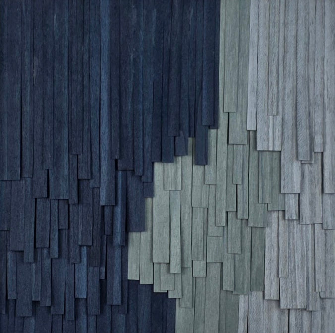 Textured wall with alternating dark and light blue rectangular patterns