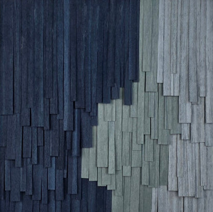 Textured wall with alternating dark and light blue rectangular patterns