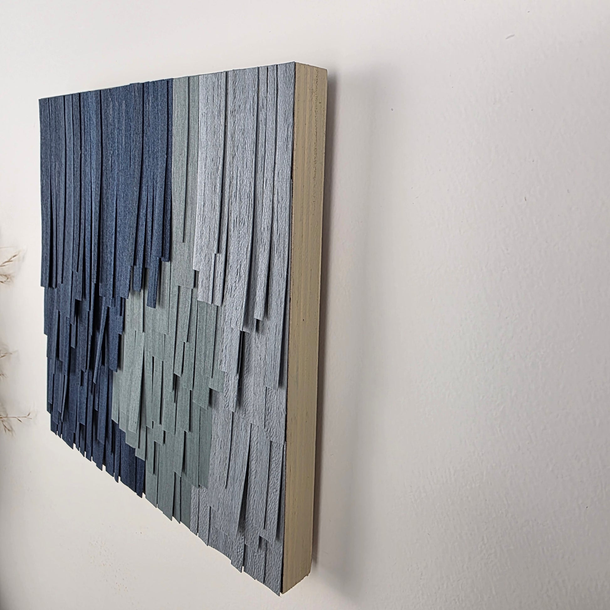 Decorative wall art with horizontal wood strips on a white background