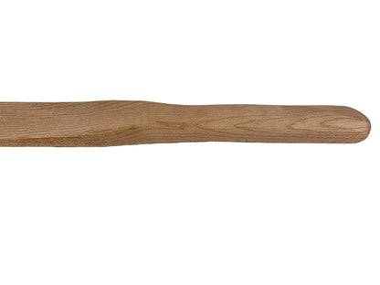 Wooden spurtle on a light gray surface