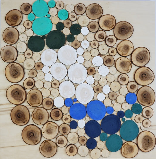 Artistic arrangement of wooden circles with teal, blue, and white accents on a white background